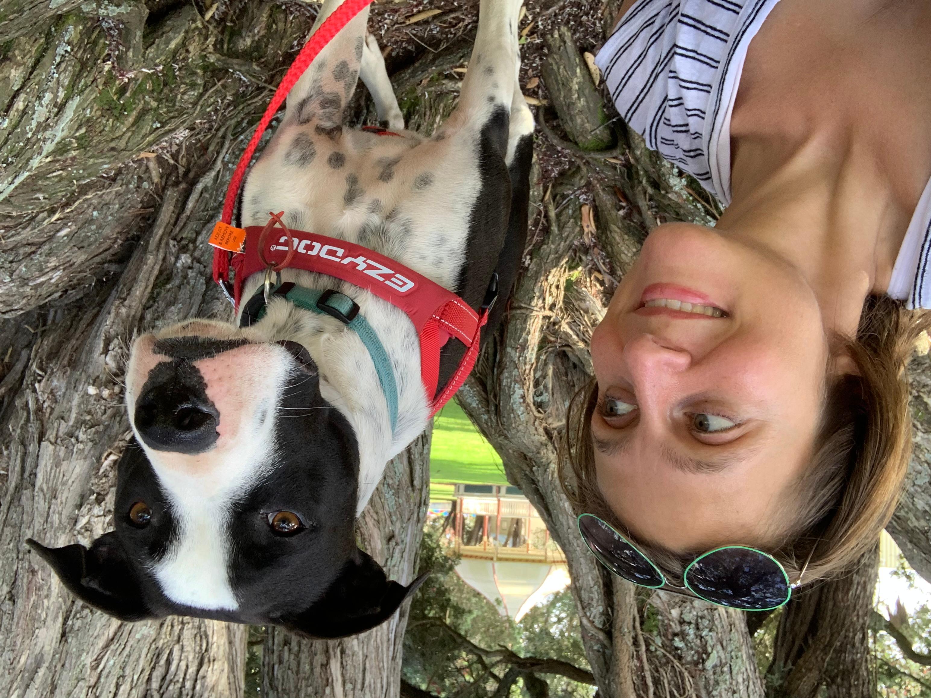 Ompractice teacher Anjali Sunita with puppy Prince in a tree