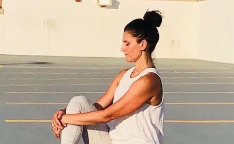 Claudia Cavazza,sitting against a textured gray background