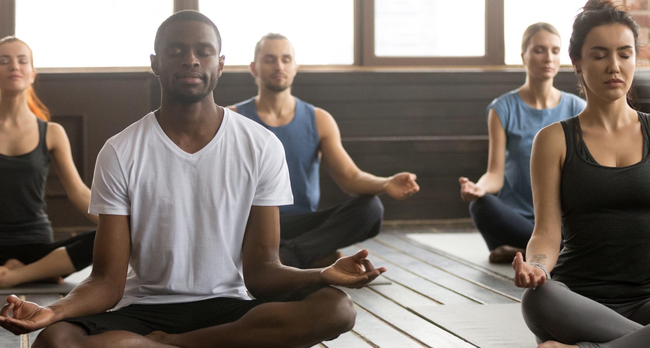 A group of people meditating in Easy Pose