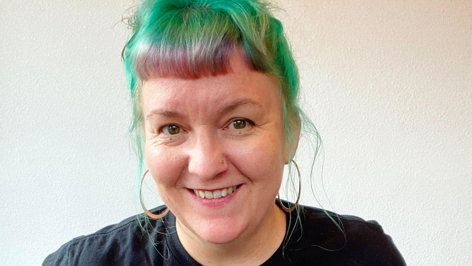 Ompractice teacher Agni Hogaboom headshot with striped shirt