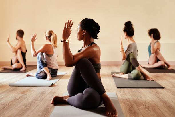 A person in an assisted forward fold