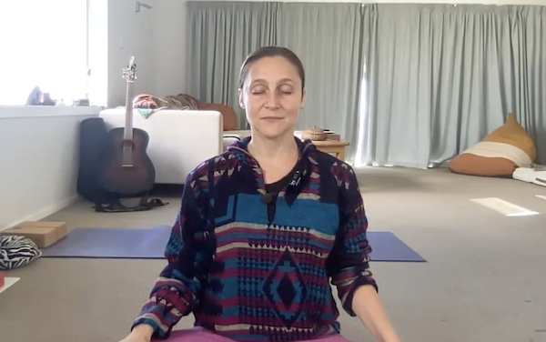 Ompractice teacher Anjali Sunita seated doing breathwork