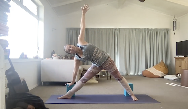 Ompractice teacher Anjali Sunita does a triangle on a mat