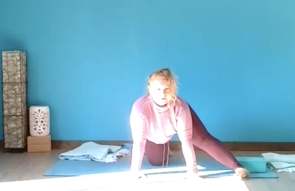 Ompractice teacher Allison Jeraci demonstrates a pose on a mat