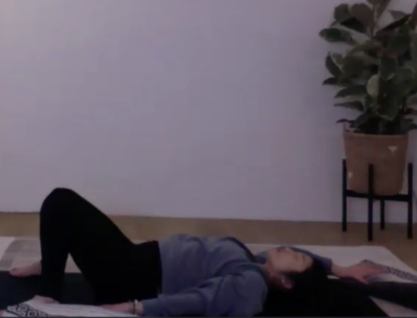 Ompractice teacher Christine Engelfried seated on a meditation cushion with natural background