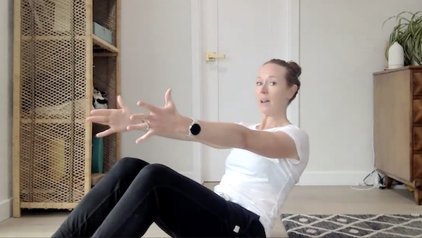 Ompractice teacher Val Minos in boat pose