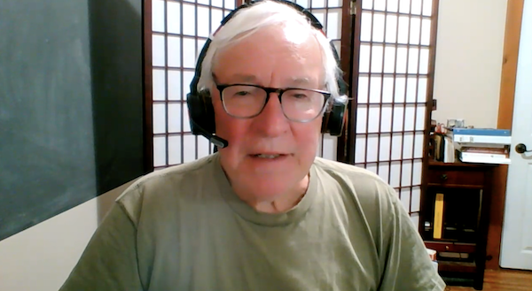 Ompractice teacher and founder of Phoenix Rising Yoga Therapy Michael Lee head shot in gray shirt with black background