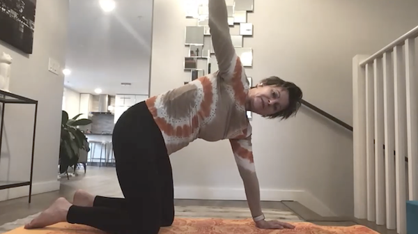 Ompractice teacher Hania Banc headshot with fake beach background