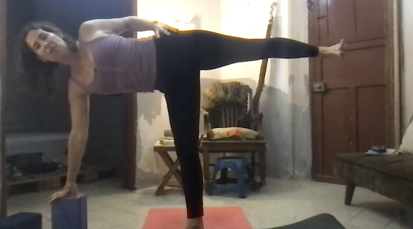 Ompractice teacher Jane Cargill sitting in lotus pose with green tanktop