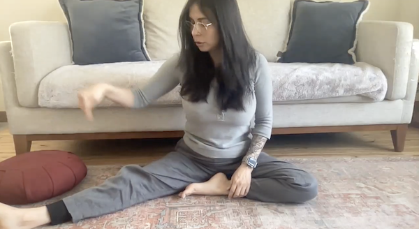 Ompractice teacher Nadja Villegas headshot with leaf earrings