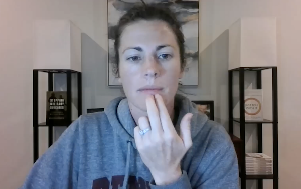 Ompractice teacher Sarah Plummer Taylor with hands in lotus