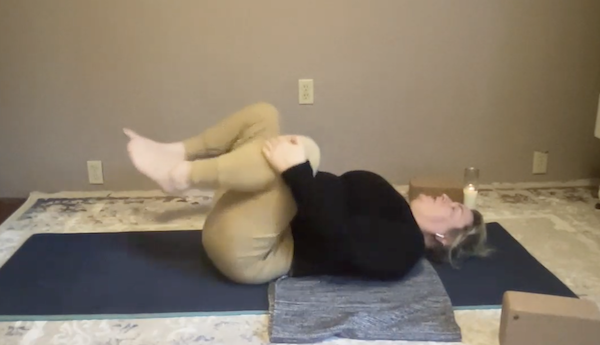 Ompractice teacher Agni Hogaboom seated with teal sweatshirt