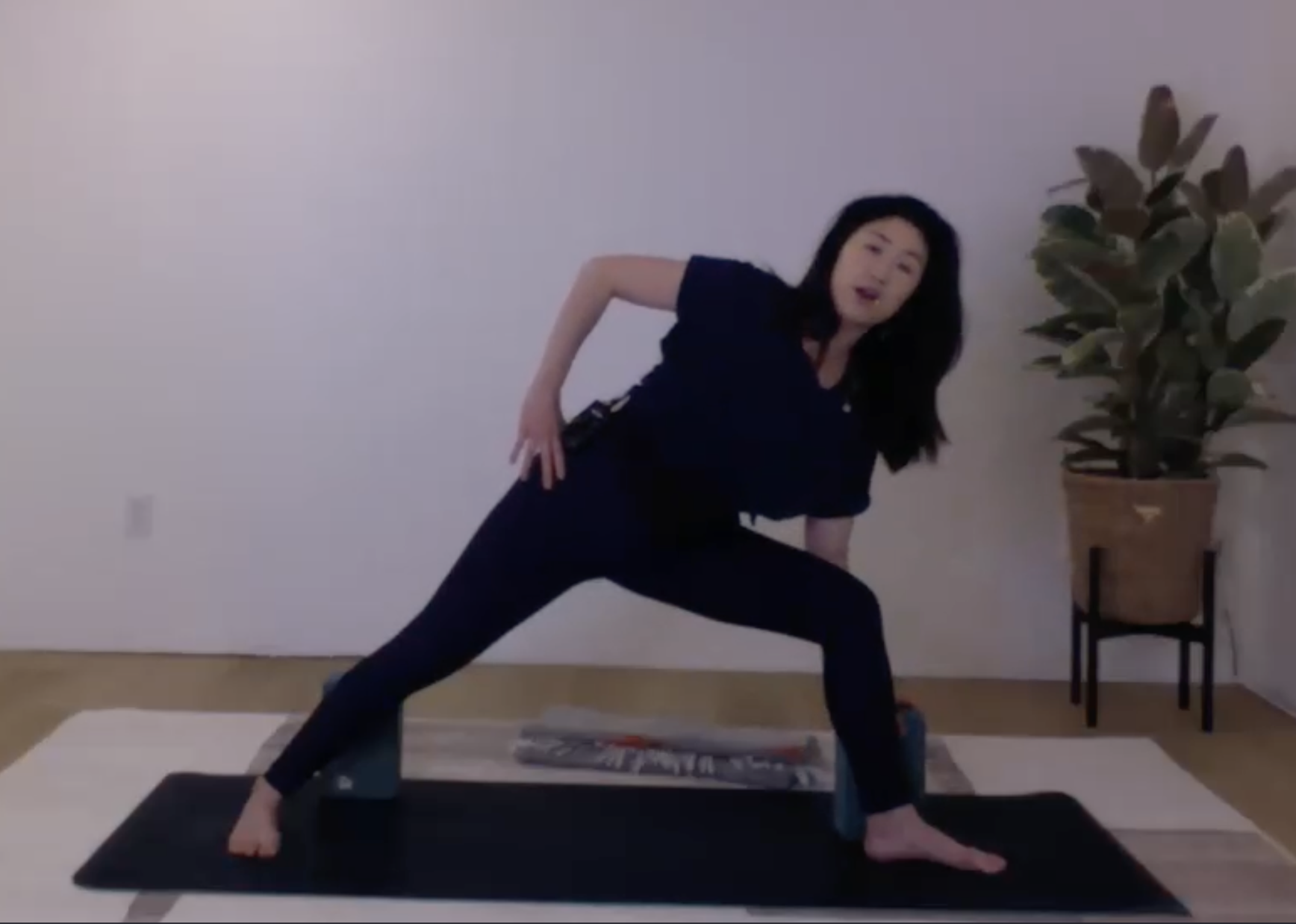 Ompractice teacher Christine Engelfried headshot in pink shirt with arm overhead