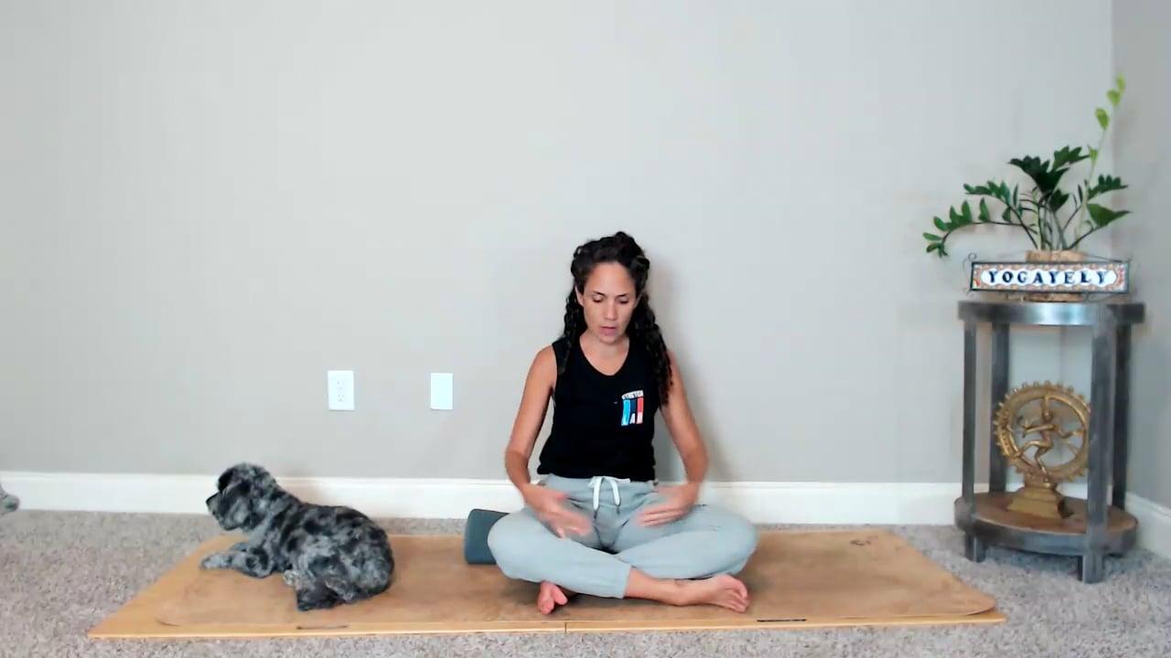 Ompractice teacher Yely on her back on a mat with a blanket over legs