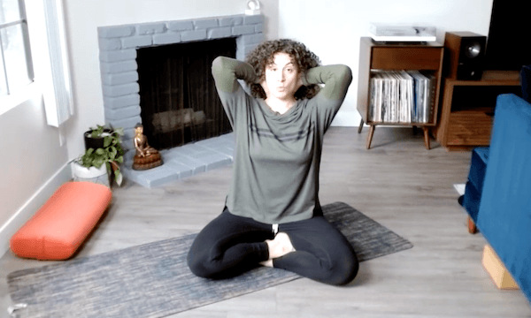 Ompractice teacher Niki Saccareccia in boat pose in bed