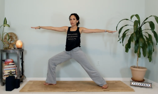 Ompractice teacher Yely Rivas demonstrating a yoga pose on the mat
