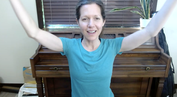 Ompractice teacher Marie doing a seated arm stretch