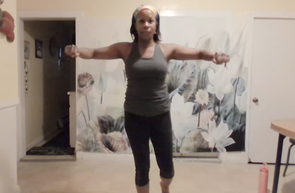 Ompractice teacher Charisse Burrus raising arms up laterally