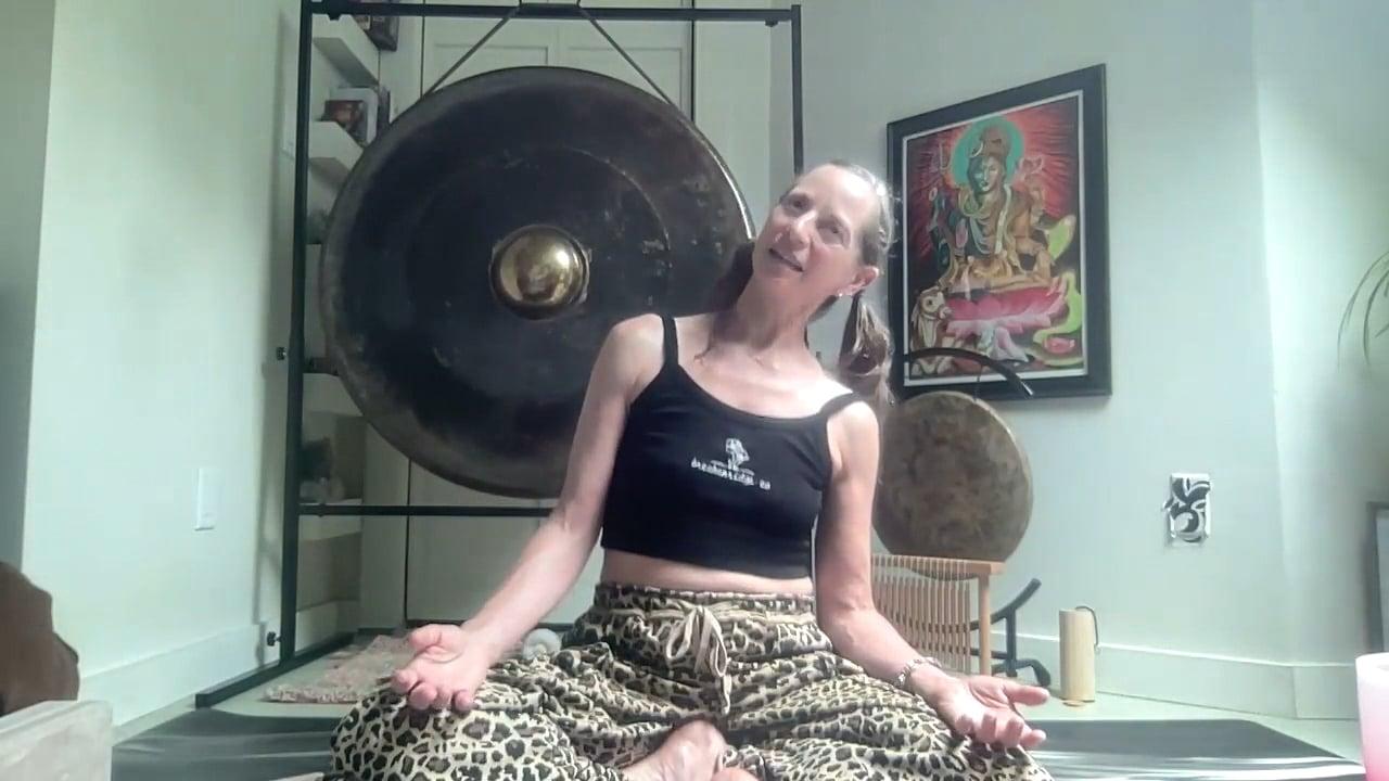 Ompractice teacher Emily Wiadro seated and stretching