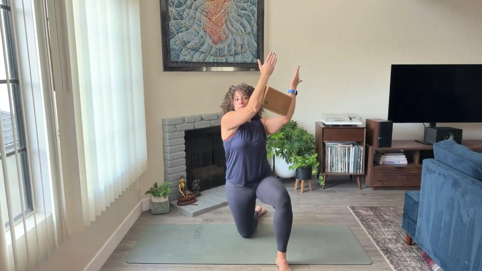 Ompractice teacher Niki Saccareccia on floor with a block in arms