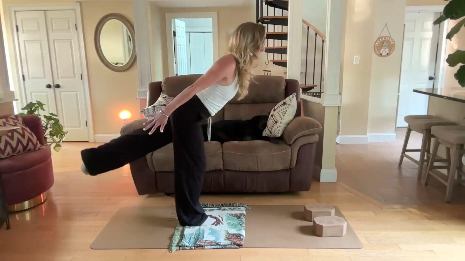 Ompractice teacher Dannika Ross standing on a mat with leg kicked back