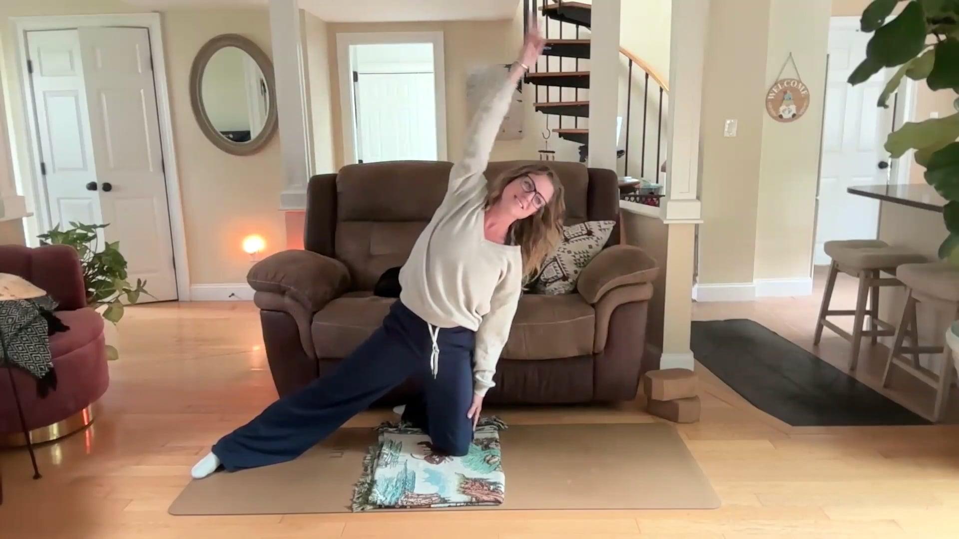Ompractice teacher Dannika Ross on a yoga mat in a yoga pose
