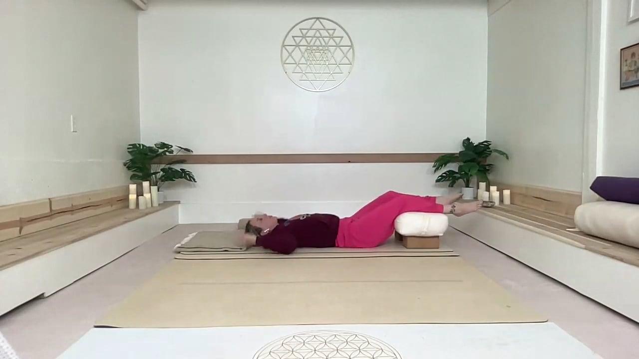Ompractice teacher Prema Posner lying down on a mat