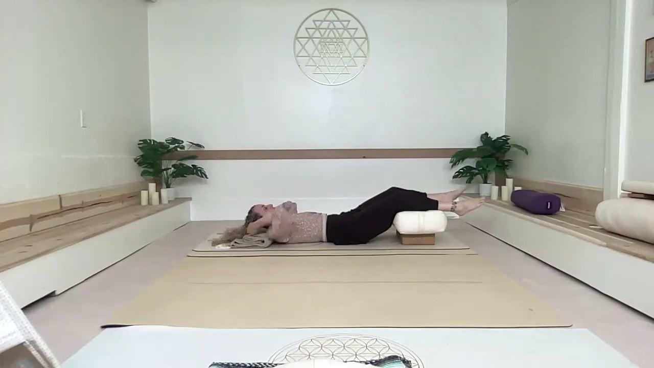 Ompractice teacher Prema lying on a mat