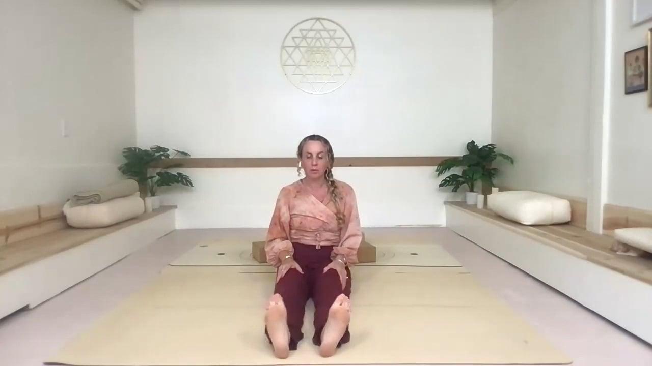 Ompractice teacher Prema Posner seated with legs out