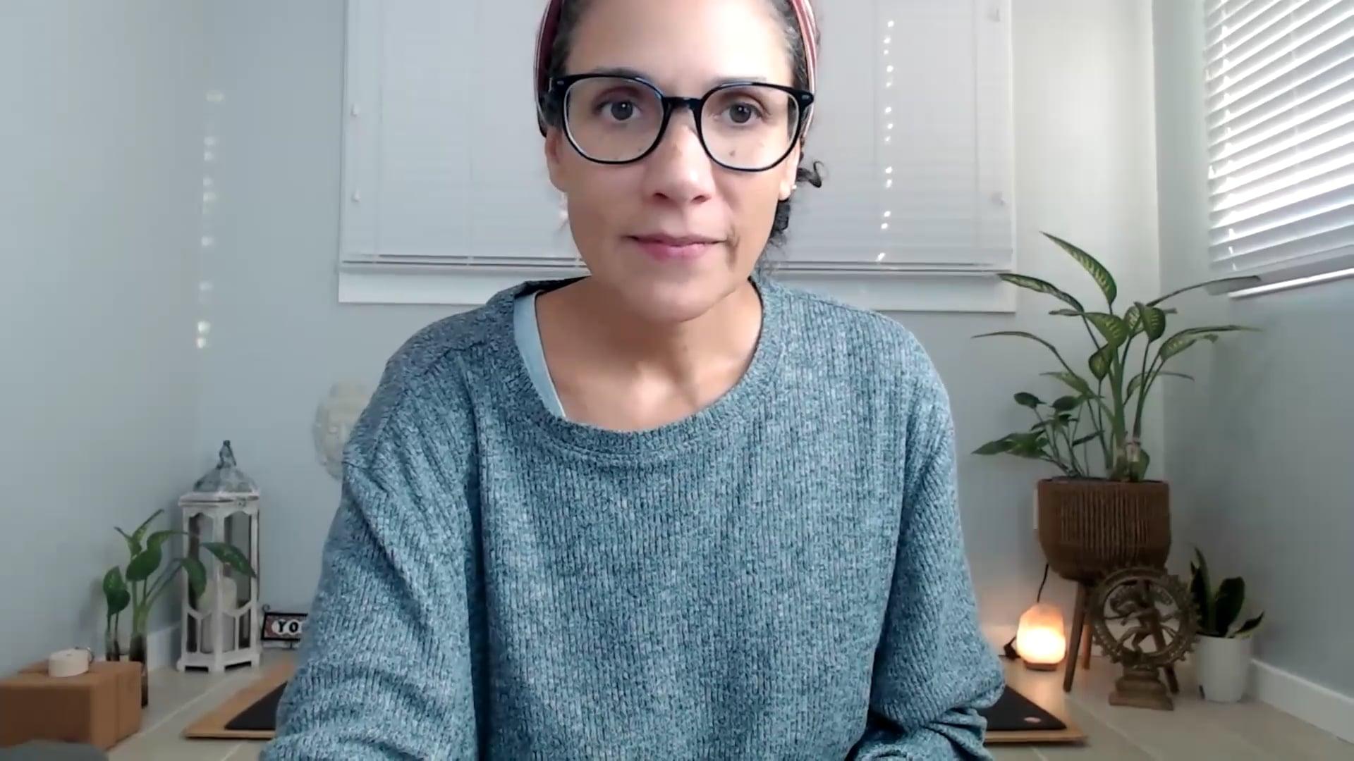 Ompractice yoga teacher Yely Rivas sitting at her desk