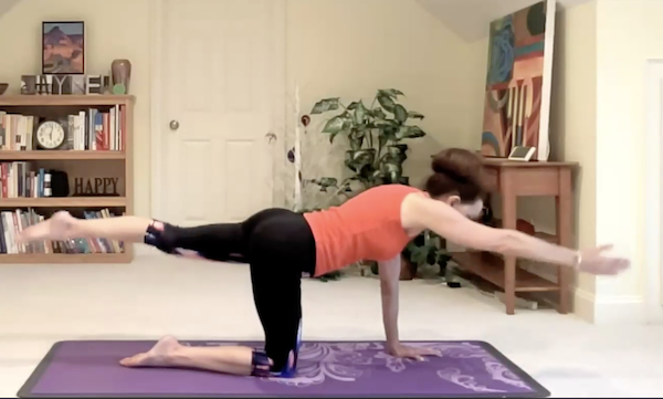 Ompractice Teacher Jayne Schmitz doing a pilates pose