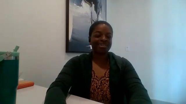 Ompractice teacher Alynthia Penn seated at a desk