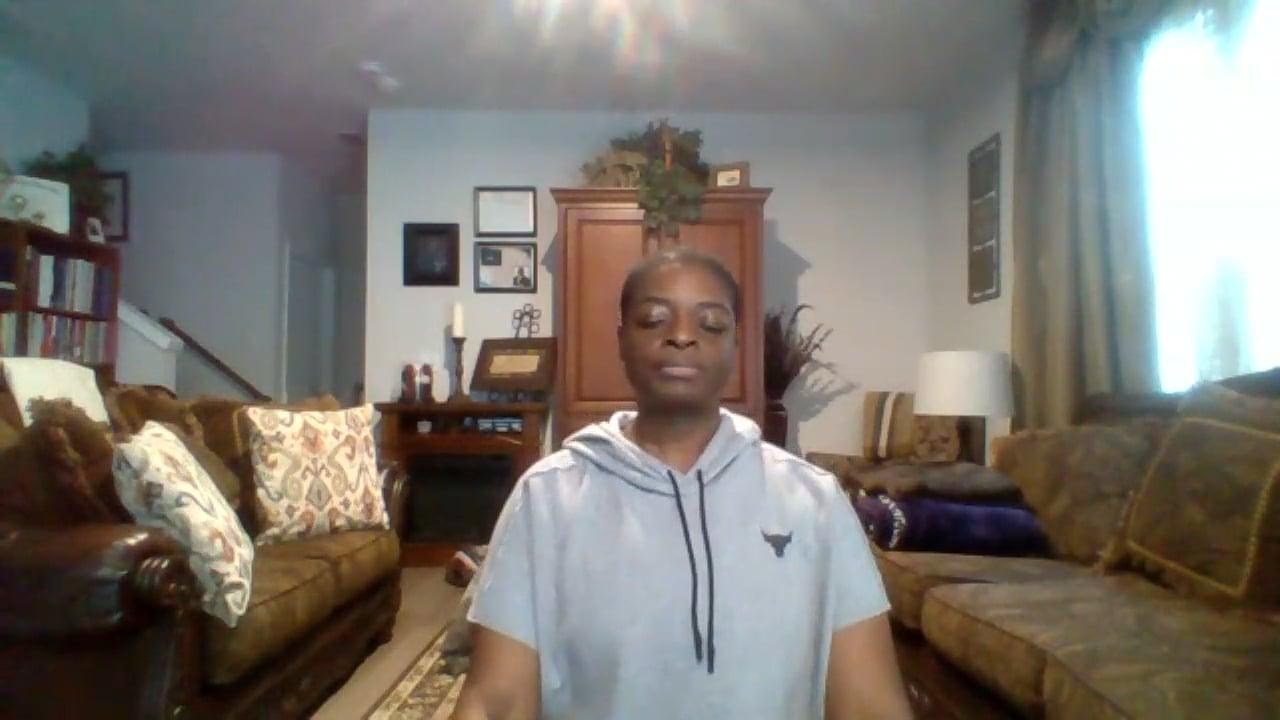 Ompractice teacher Alynthia Penn seated with eyes closed