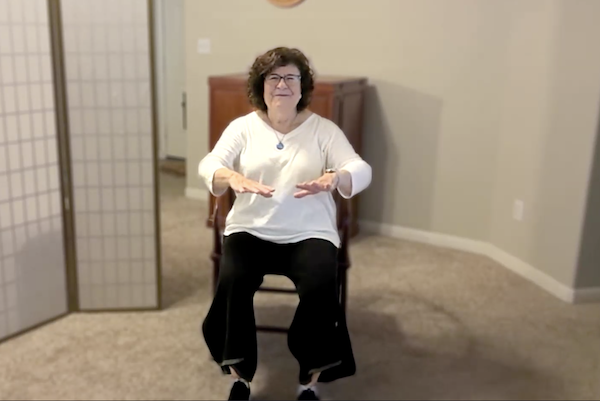 Ompractice teacher Patricia Lawson teaching seated tai chi