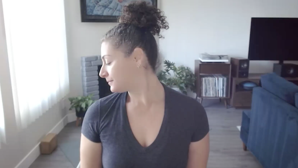 Ompractice teacher Niki turning her neck in a chair